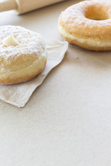 closeup donut on paper texture with warm fall colors, soft-focus in the background. over light