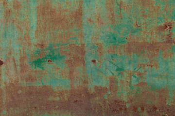 Rusty surface of green metal plate. Rusty texture backdrop. Rust on old metal. Rust on old green fence. Grunge ruststained metal fence. Mildew on green iron-plate fencing. Seedy bingery paling