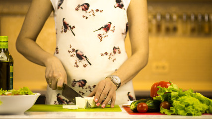 woman preparing a greek salad