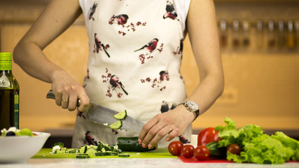 woman preparing a greek salad