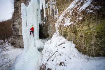 The climber climbs on ice.