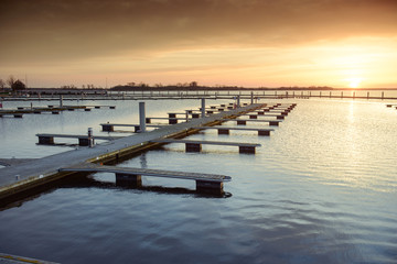 Obraz premium Yacht port over orange sunset