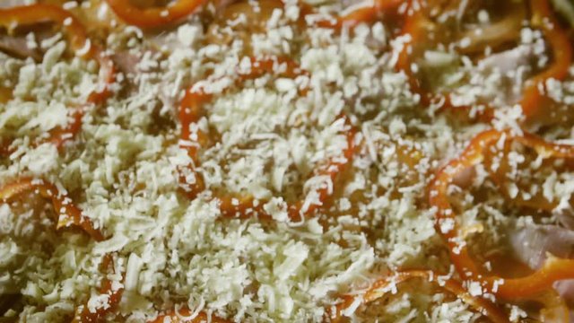 cheese falling on pizza closeup slow motion