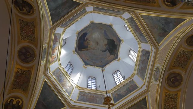 High Dome Ceiling With God Father Image in Church Belonging to Orthodox Christianity in Kiev, With Old Round Windows, Saint Images, Splendid Chandelier