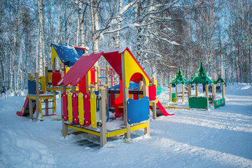 Children's Playground in the winter snow Park