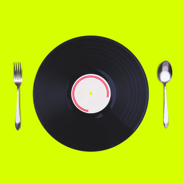 Music Mania Concept. Retro Record, Spoon & Fork Isolated On Green. Listen Music Instead To Eat