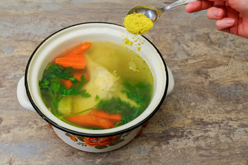 Chicken soup in a bowl with crackers.