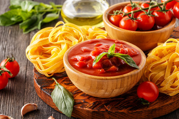 Products for cooking - tomato sauce, pasta, tomatoes, garlic.