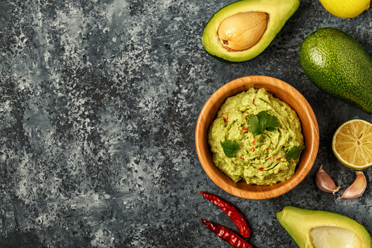 Homemade guacamole with ingredients.