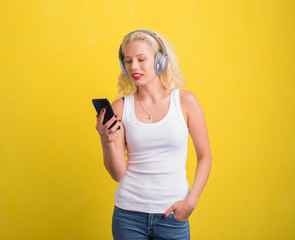 Woman listening to music on headset from her phone