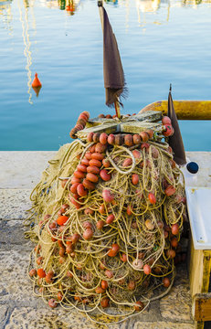 Fishing nets placed on the dock of a port by fishermen