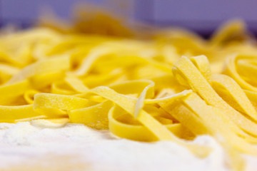 Fresh pasta handmade Tagliatelle is on the table, awaiting prepa