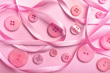various pink buttons with pink ribbon.