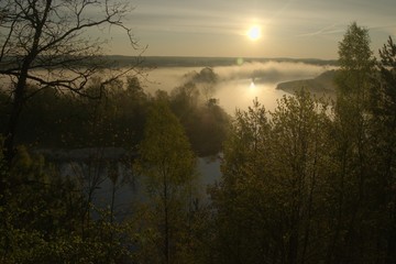 Sunrise. The river in the mist. A view of the meadows and the river in the morning.