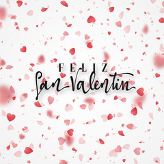 Happy Valentines Day. lettering Spanish Inscription handmade. Greeting card. Bright red hearts flying in the form of petals on a white background. Pink heart in frame.