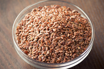 flax seeds in bowl on table background