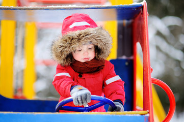 Fototapeta na wymiar Cute little boy having fun on playground