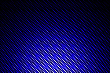 spotlight on blue carbon fiber background.