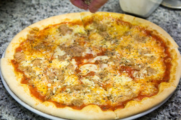 Pizza cooking. The chef prepares the stuffing .