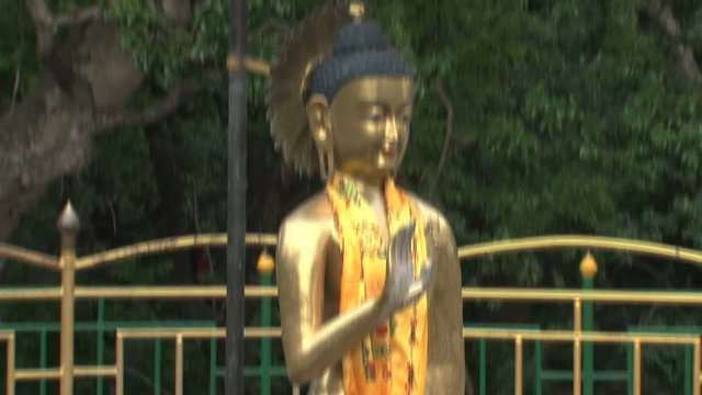 Missing and a Tilt from a bucket with coints to Golden Buddha