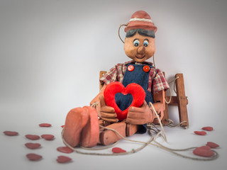 Puppet with red heart in retro style