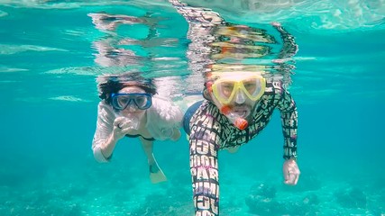 Diving on the island of Bali. The young couple dives with aqualungs. On the island of Bali there is everything that is necessary for good diving: ideal water temperature, excellent visibility.