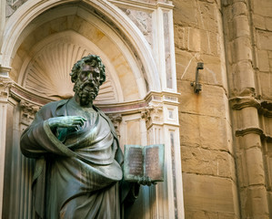 statue holding a bible