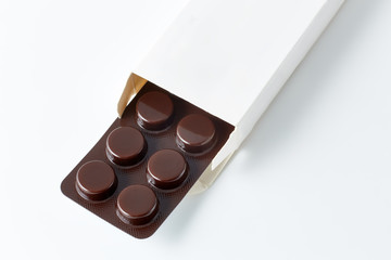 Aluminium blister pack of pills. The capsules are packaged in blisters, isolated on a white background. Disease. Flu. Medications.