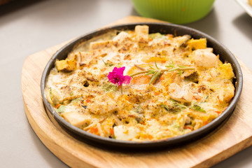 Hot plate Omelette eggs with salted fish and mushroom.