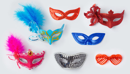 Carnival or mardi gras masks on white background for mock up template design. View from above. Flat lay