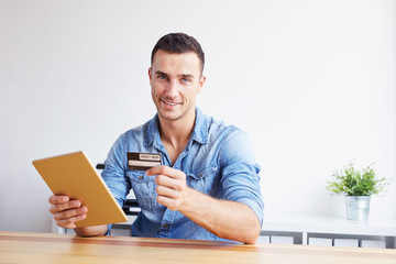 Man holding credit card and digital tablet