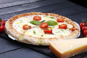Hot true PEPPERONI ITALIAN PIZZA with salami and cheese. TOP VIEW Tasty traditional pepperoni pizza on board on wooden table with decoration