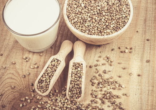 Hemp milk, seeds on wooden background . Close Up .