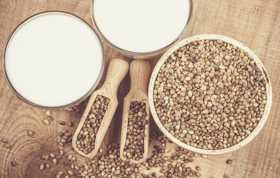 Hemp milk, seeds on wooden background . Close Up .