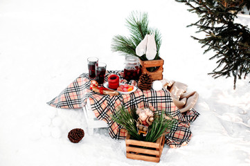 decorated table served for two. Romantic picnic in winter.