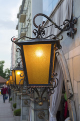 Street lamp in retro style lights in the evening. Architecture