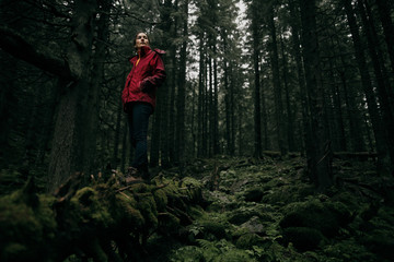 Young woman tourist walking along the trail in the rain forest