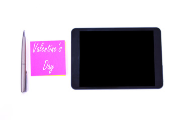 tablet, pen, and blocknote with message of valentines