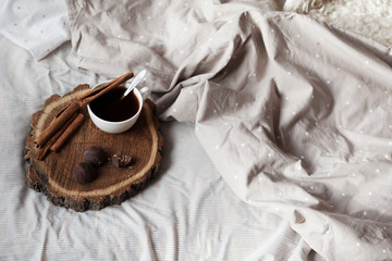 on the bed is a tray of coffee