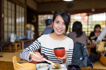 Woman enjoy her lunch in Japanese restaurant