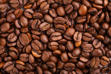 roasted coffee beans isolated in white background. Roasted coffee beans background close up. Coffee beans pile from top on white background with copy space for text. Good morning.