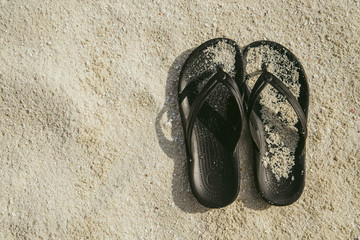 Fototapeta na wymiar Beach shoes sandals flip-flops on sandy beach