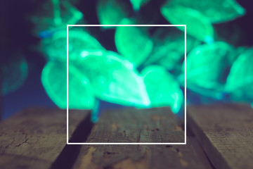 Wooden boards on a green spring background blurred leaves in the frame