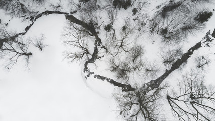 Aerial view over a frozen creek during winter