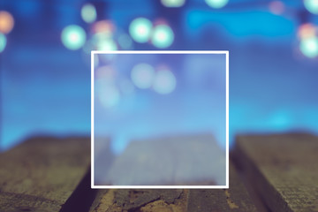 Wooden boards on bokeh background in frame