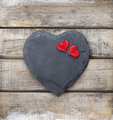 Stone heart on wooden background