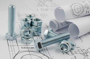 Mechanical Engineering Technology. Nuts and bolts on paper drawings