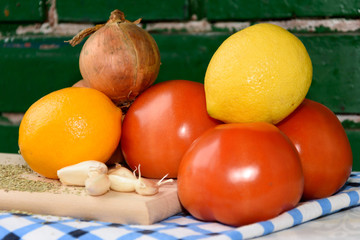 Vegetables tomato onion garlic lemon seasoning cutting board