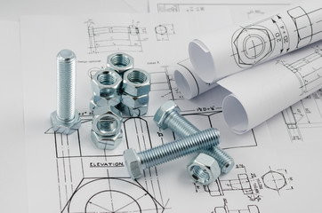 Mechanical Engineering Technology. Nuts and bolts on paper drawings