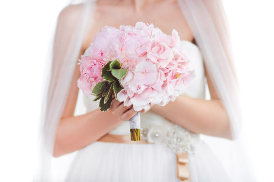 Bridal bouquet Beautiful of pink wedding flowers in hands of the bride